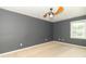 Spacious bedroom with neutral carpet, ceiling fan, gray walls, and window, perfect for relaxation at 7372 Deerfield Dr, Greenfield, IN 46140