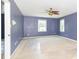 Bedroom painted blue with ceiling fan and two windows at 7372 Deerfield Dr, Greenfield, IN 46140