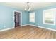 Dining room featuring laminate floors, neutral walls, and natural light from the two windows at 7372 Deerfield Dr, Greenfield, IN 46140