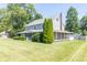 Well-maintained two-story home with a lush green lawn and mature trees offering shade at 7372 Deerfield Dr, Greenfield, IN 46140