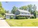 Inviting two-story home with a spacious yard, complemented by mature trees and landscaping at 7372 Deerfield Dr, Greenfield, IN 46140