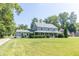Charming two-story home featuring a spacious front yard and welcoming covered porch at 7372 Deerfield Dr, Greenfield, IN 46140