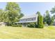 Attractive two-story residence featuring a well-manicured lawn and covered front porch at 7372 Deerfield Dr, Greenfield, IN 46140