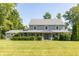Charming two-story home featuring a covered porch and well-manicured lawn at 7372 Deerfield Dr, Greenfield, IN 46140