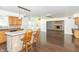 Open concept kitchen flowing into the living area with a center island and maple cabinets at 7372 Deerfield Dr, Greenfield, IN 46140