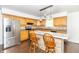 Well-lit kitchen features stainless steel appliances, light wood cabinets, and a breakfast bar with stylish pendant lighting at 7372 Deerfield Dr, Greenfield, IN 46140
