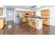 Open-concept kitchen boasts a large island with marble countertop, stainless steel appliances, and hardwood floors at 7372 Deerfield Dr, Greenfield, IN 46140