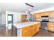 Open kitchen with a center island, stainless steel appliances, and maple cabinets at 7372 Deerfield Dr, Greenfield, IN 46140