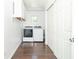 Bright laundry room with hardwood floors, white washer/dryer, and storage cabinets offers functionality and style at 7372 Deerfield Dr, Greenfield, IN 46140