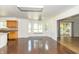 Bright living room featuring hardwood floors, large windows with a cushioned window seat, and access to the deck at 7372 Deerfield Dr, Greenfield, IN 46140