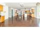 Open concept living area with hardwood flooring flowing into the kitchen with stainless steel appliances and an island at 7372 Deerfield Dr, Greenfield, IN 46140