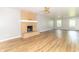 Bright living room with new flooring and a cozy brick fireplace feature at 7372 Deerfield Dr, Greenfield, IN 46140