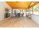 Screened-in porch with wood floors, a dining table, and views of the backyard creates a relaxing space at 7372 Deerfield Dr, Greenfield, IN 46140