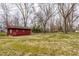 Large backyard with outbuilding, offering ample space and potential at 7806 Meadowbrook Dr, Indianapolis, IN 46240