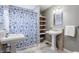 Traditional bathroom featuring pedestal sinks, tiled floors, and a shower with a patterned curtain at 7806 Meadowbrook Dr, Indianapolis, IN 46240