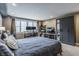 Cozy bedroom featuring a large bed, workspace with dual monitors, and ample closet space at 7806 Meadowbrook Dr, Indianapolis, IN 46240