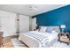 A spacious bedroom featuring a blue accent wall, large bed, and built-in wardrobe at 7806 Meadowbrook Dr, Indianapolis, IN 46240