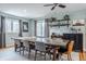 Bright dining room features hardwood floors, a large wood table, and a charming bar area with decorative shelving at 7806 Meadowbrook Dr, Indianapolis, IN 46240