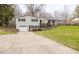 Well-maintained home with a long driveway and beautifully landscaped front yard at 7806 Meadowbrook Dr, Indianapolis, IN 46240