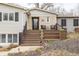 Inviting front porch with seating, leading to a charming home with curb appeal at 7806 Meadowbrook Dr, Indianapolis, IN 46240