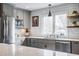 Modern kitchen featuring quartz countertops, subway tile backsplash, and stainless steel appliances at 7806 Meadowbrook Dr, Indianapolis, IN 46240