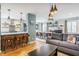 Open-concept living room showcasing a modern kitchen, hardwood floors, and stylish decor at 7806 Meadowbrook Dr, Indianapolis, IN 46240