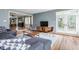 Open living space with a view into the dining area, hardwood floors, and contemporary furniture at 7806 Meadowbrook Dr, Indianapolis, IN 46240