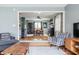 Open-concept living space with hardwood floors, stylish furniture, and a view into the dining area at 7806 Meadowbrook Dr, Indianapolis, IN 46240
