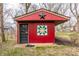 Charming red outbuilding or shed with decorative star and quilt square on property at 7806 Meadowbrook Dr, Indianapolis, IN 46240