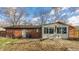 The home's rear features a patio, sunroom, brick facade, and grassy area at 7939 Sharon Dr, Avon, IN 46123