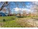 Spacious backyard with a trampoline, patio, storage sheds, and a wooden fence at 7939 Sharon Dr, Avon, IN 46123