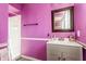 This bathroom features a sink, a shower, and purple walls at 7939 Sharon Dr, Avon, IN 46123