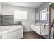 This bathroom features a standalone tub, double sinks, and geometric tiling at 7939 Sharon Dr, Avon, IN 46123