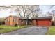 Cozy single-story brick home featuring an attached garage and a basketball hoop out front at 7939 Sharon Dr, Avon, IN 46123