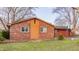 Charming brick home featuring tidy landscaping, a red garage door, and a basketball hoop at 7939 Sharon Dr, Avon, IN 46123