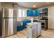 Recently updated kitchen featuring blue cabinets, stainless steel appliances, and modern lighting at 7939 Sharon Dr, Avon, IN 46123