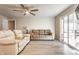 Bright living room features hardwood floors, ceiling fan and sliding glass doors at 7939 Sharon Dr, Avon, IN 46123