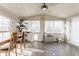 This sunroom features lots of light, wood paneling, and a dining area at 7939 Sharon Dr, Avon, IN 46123