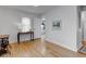 Bright bedroom with hardwood floors, a window letting in natural light, and a decorative table with lamp at 805 N Tuxedo St, Indianapolis, IN 46201