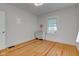 Clean, minimalist bedroom with hardwood flooring and neutral tones at 805 N Tuxedo St, Indianapolis, IN 46201