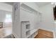 Spacious walk-in closet offering ample storage and organization, with hardwood floors and natural light at 805 N Tuxedo St, Indianapolis, IN 46201