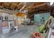 Spacious garage interior with exposed ceiling beams, storage shelving, and an open layout at 805 N Tuxedo St, Indianapolis, IN 46201