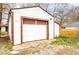 Detached garage with a large garage door and ample space for parking and storage at 805 N Tuxedo St, Indianapolis, IN 46201