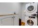 Convenient laundry area with stacked washer and dryer, a wooden countertop, and storage at 805 N Tuxedo St, Indianapolis, IN 46201