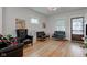 Cozy living room featuring refinished hardwood floors and ample seating at 805 N Tuxedo St, Indianapolis, IN 46201