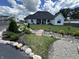 Charming backyard with lush landscaping and a wood bridge with a view of the home at 8146 W 875 S, Pendleton, IN 46064