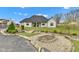Charming backyard featuring a fire pit, lush landscaping and a wood bridge with a view of the home at 8146 W 875 S, Pendleton, IN 46064