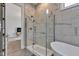 Bright bathroom featuring a glass shower, tub, and marble tile at 8146 W 875 S, Pendleton, IN 46064