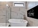 Contemporary bathroom with a sleek soaking tub, glass-enclosed shower, and stylish gray tile at 8146 W 875 S, Pendleton, IN 46064