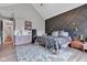 Spacious bedroom boasts a gray accent wall, light wood floors, and a built-in wet bar at 8146 W 875 S, Pendleton, IN 46064